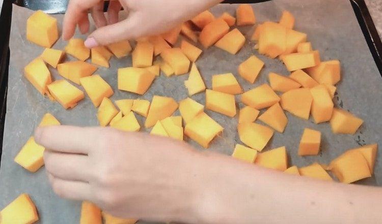 put slices of pumpkin on a baking sheet and bake in the oven.