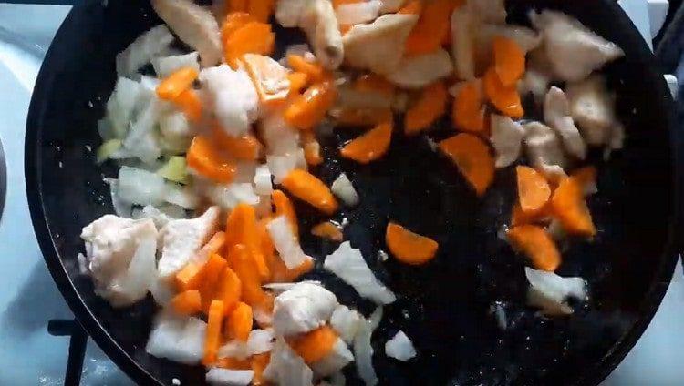 Add carrots with onions to the pan to the chicken.