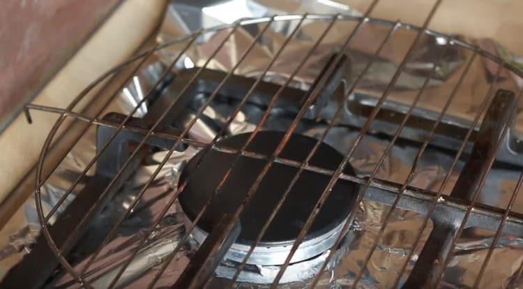 Couvrir le poêle avec du papier d'aluminium, mettre un barbecue sur le dessus.