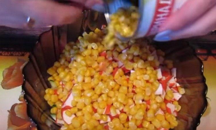Add canned corn to the salad.