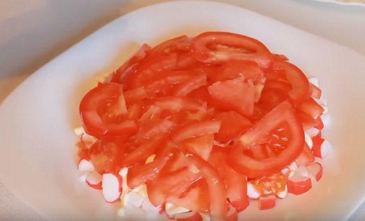put the slices of tomatoes.