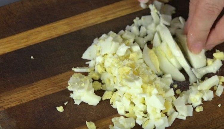 Cook hard-boiled eggs and crumbling them into a cube.