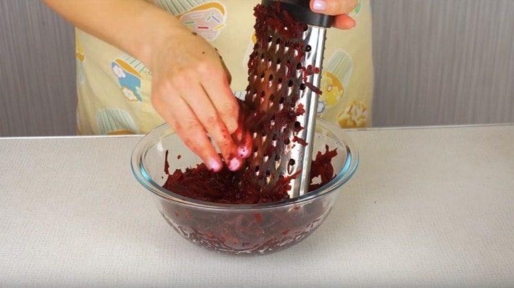 Three boiled beets on a coarse grater.