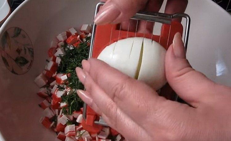Hard-boiled eggs are cut or chopped using an egg cutter.