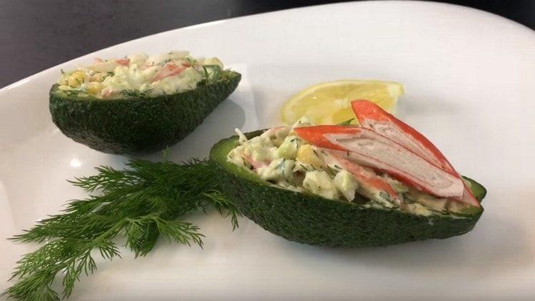 We serve a salad with avocado and crab sticks in avocado peel boats.
