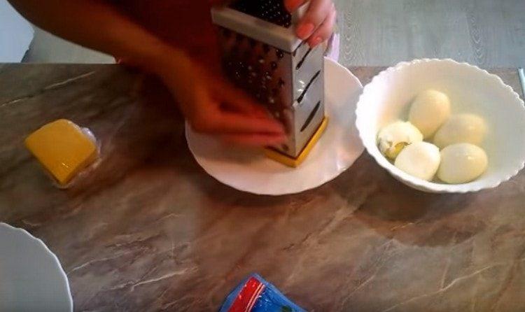 grate the eggs on a fine grater.
