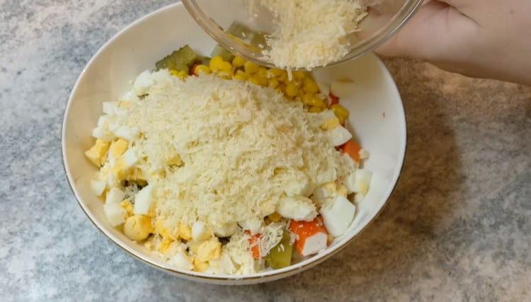 Add the grated cheese to the salad.