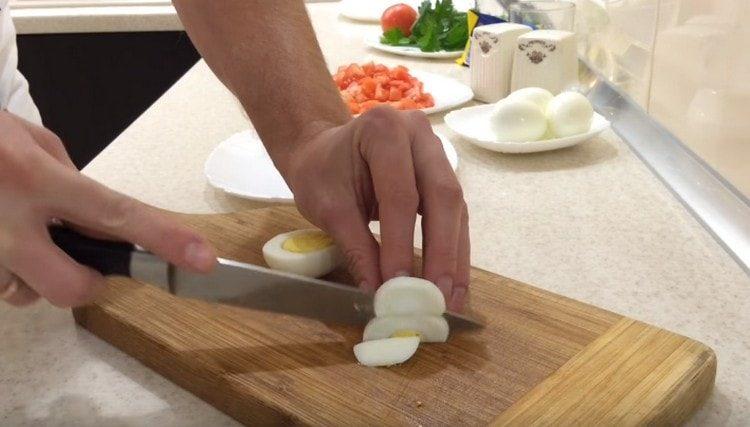 Hard-boiled eggs are cut in half rings.