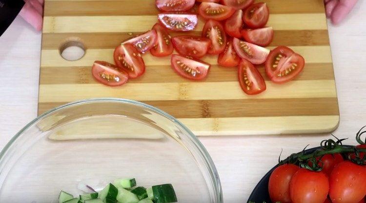 Cherry tomatoes are cut into pieces.