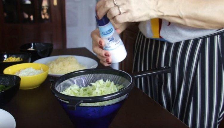 Put the cucumber in a sieve, add a little salt.