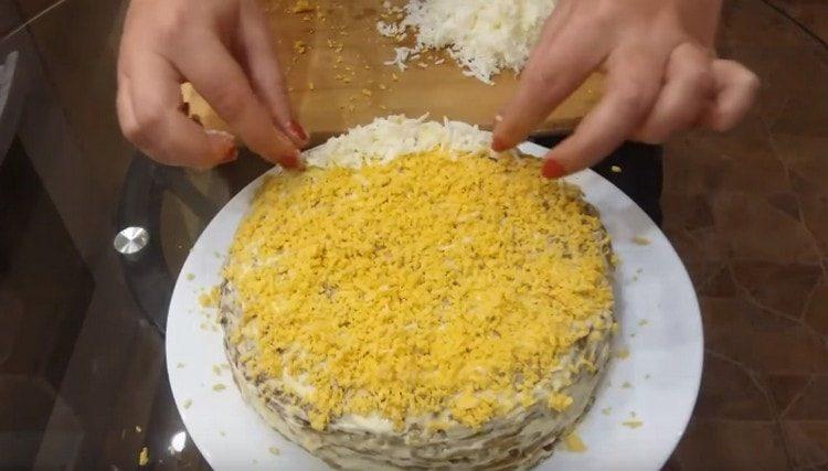 Garnish the dish with grated egg whites and yolks.