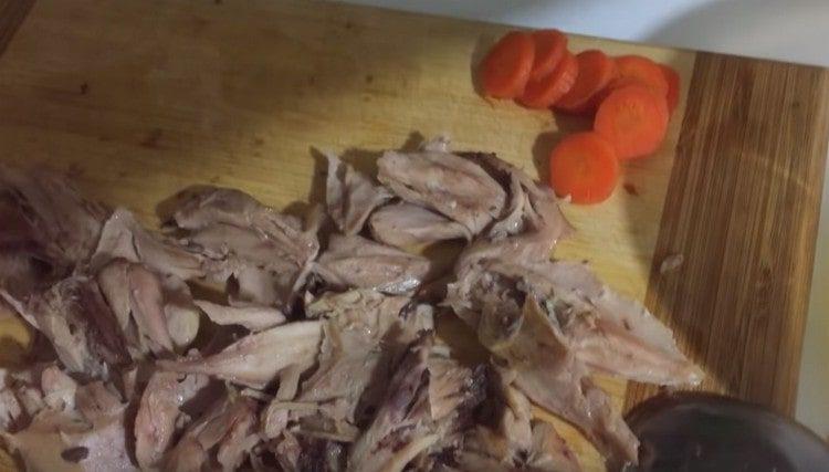 Cut carrots and meat into pieces.