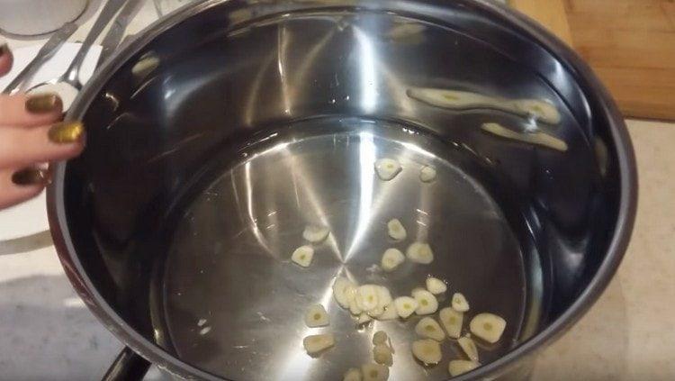 Pour water into the pan, add garlic.