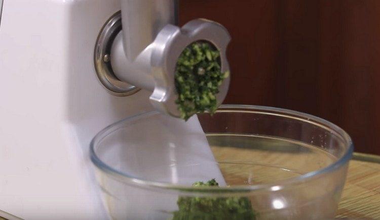 After cilantro, put the garlic in a meat grinder.
