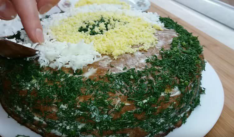 Decorate the cake with chopped dill and grated egg.