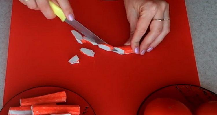 Cooking salad with crab sticks and tomatoes