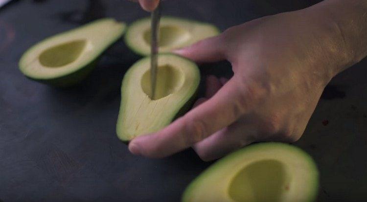 We make cuts on the flesh of an avocado.