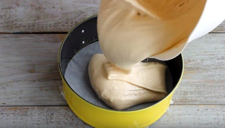 Pour the dough into a parchment-covered form and put it in the oven.