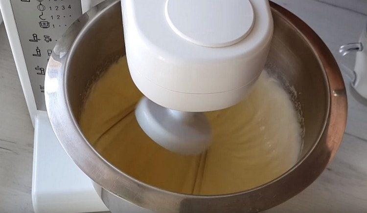 Beat eggs with sugar with a mixer until lightened.