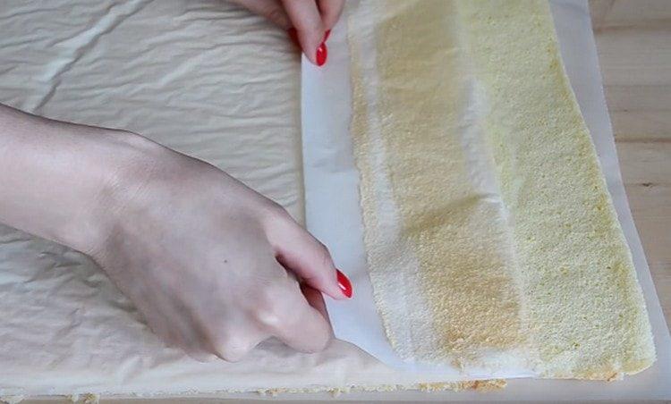 Gently turn the cake and remove the parchment from it.