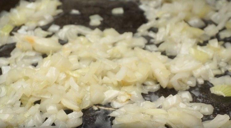 Fry chopped onions in a pan.