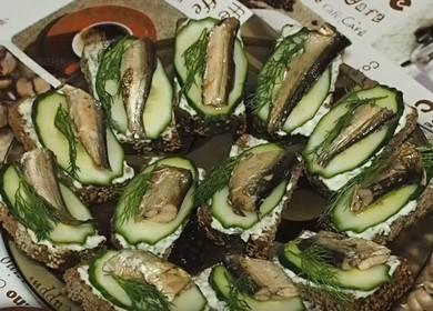 Tasty sandwiches with шп sprats and fresh cucumber