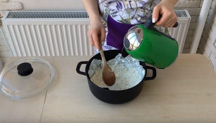 Pour rice with water and set to cook.