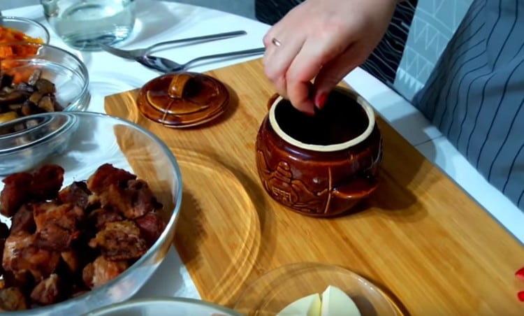 En el fondo de la olla, esparce pimientos y una hoja de laurel.