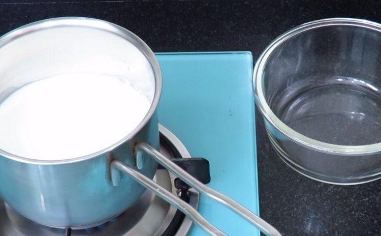 Pour milk into the stewpan and bring to a boil.