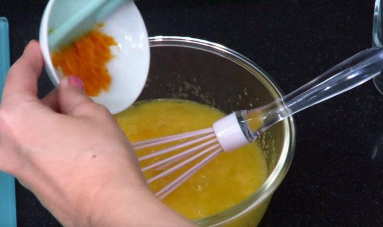 Beat eggs with sugar and add orange zest.