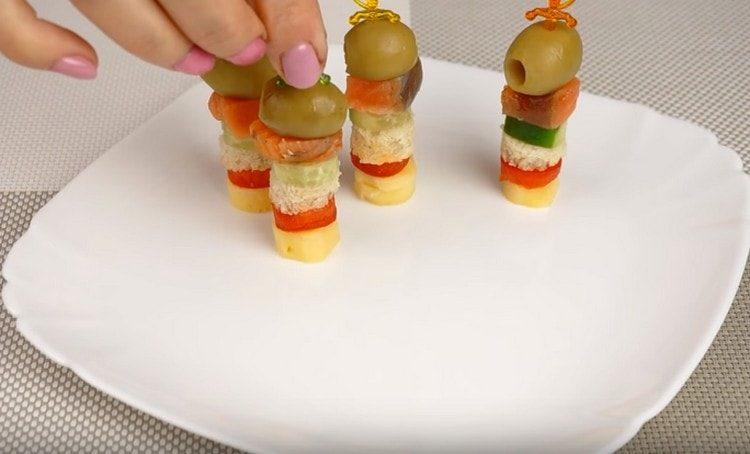 These canapes on skewers look very appetizing.