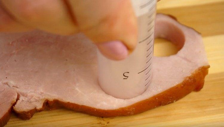 From a slice of ham, cut a circle with a syringe.