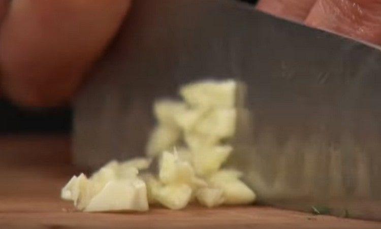 Grind the garlic with a knife.