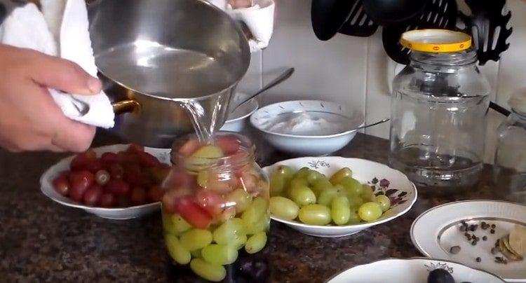 Pour the grapes in jars with boiling water.