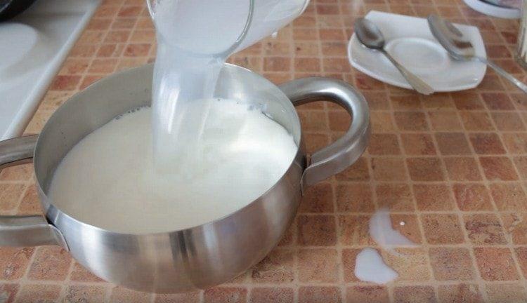 Pour milk and water into the pan.