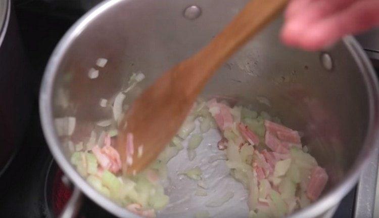 Add garlic and bacon to the onion with celery.