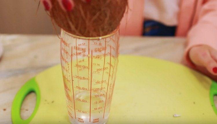 Pour milk from the coconut and add to the blender bowl.