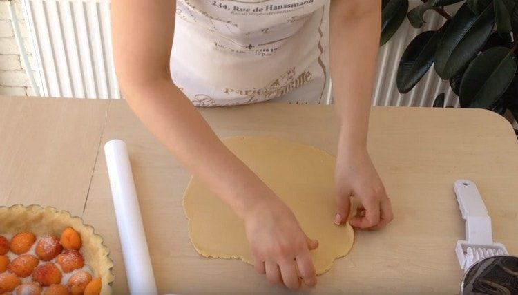 Thinly roll out a smaller portion of the dough.