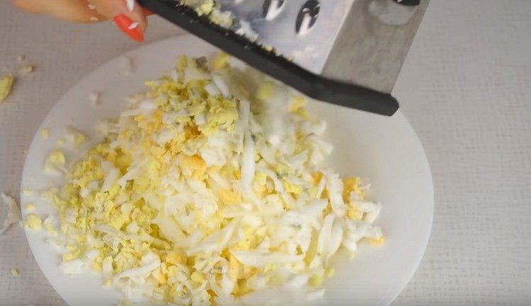 Three boiled eggs on a grater.