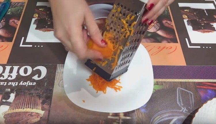 Three potatoes and carrots are also on a grater.