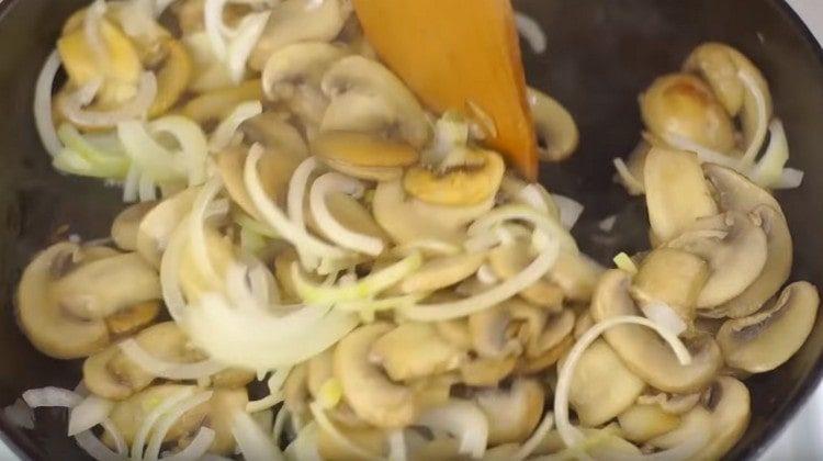 Add the onions to the mushrooms and fry all together.