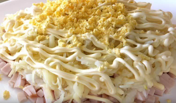 On top of the potato layer, grate the egg yolks.