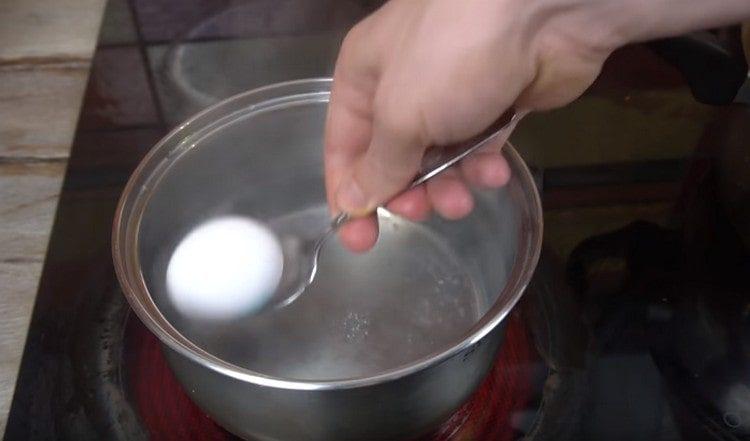 Just for a minute, immerse the egg in boiling water.