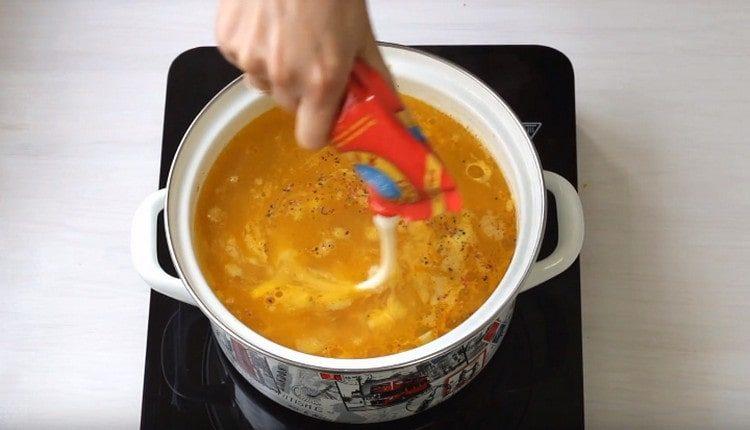Add melted cheese to the soup.