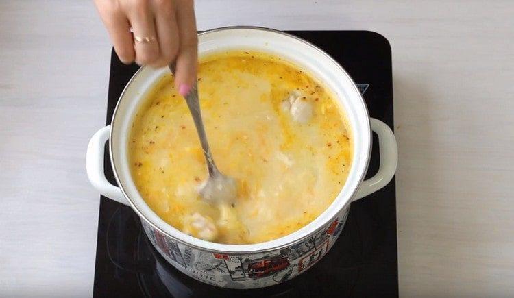 Stir the soup to dissolve the cheese.