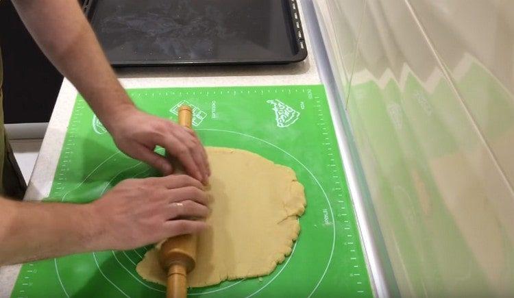 We roll out most of the dough into a circle.