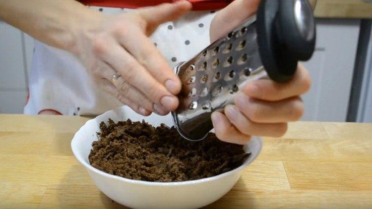 Rubbing the cake layers on a coarse grater.