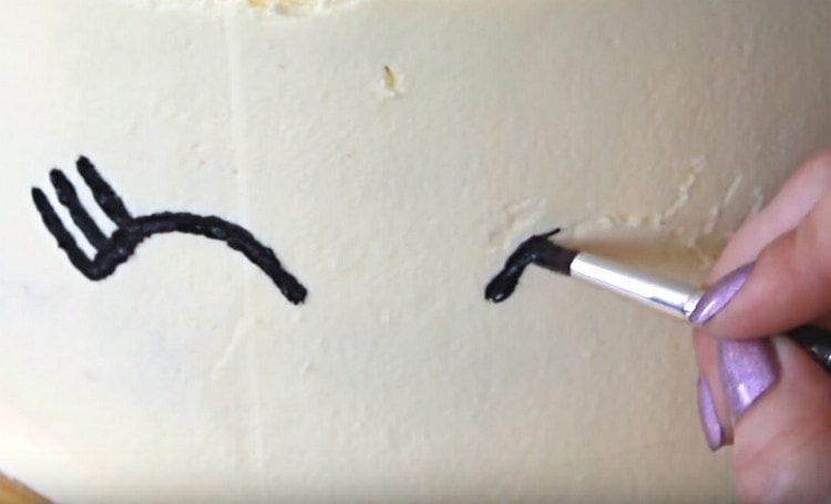 Crnom bojom hrane crtamo na torti oči jednoroga.