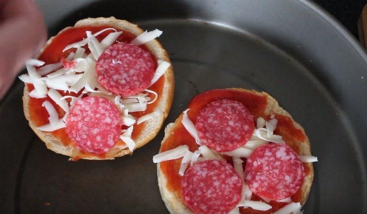 We spread cheese and salami on a bun.