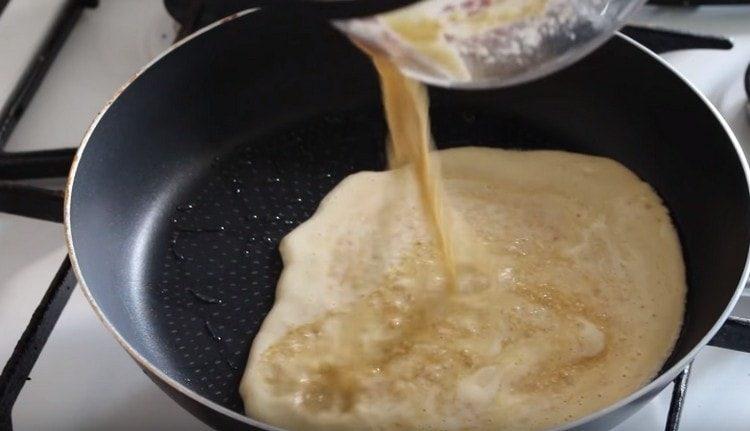 Mix the dough until smooth and pour into a preheated pan with vegetable oil.